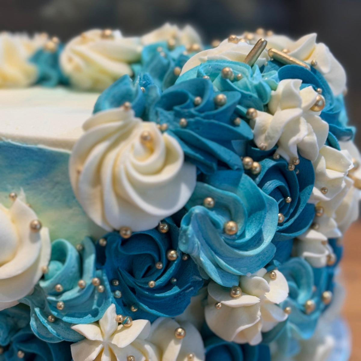 Close-up of cascading decorative details and gold accents on an elegant mud or sponge celebration cake handcrafted in Adelaide.