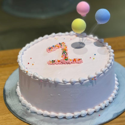 Full view of a first birthday balloon cake handcrafted in Adelaide using Ben & Jerry's ice cream, featuring cheerful balloon-inspired decorations.