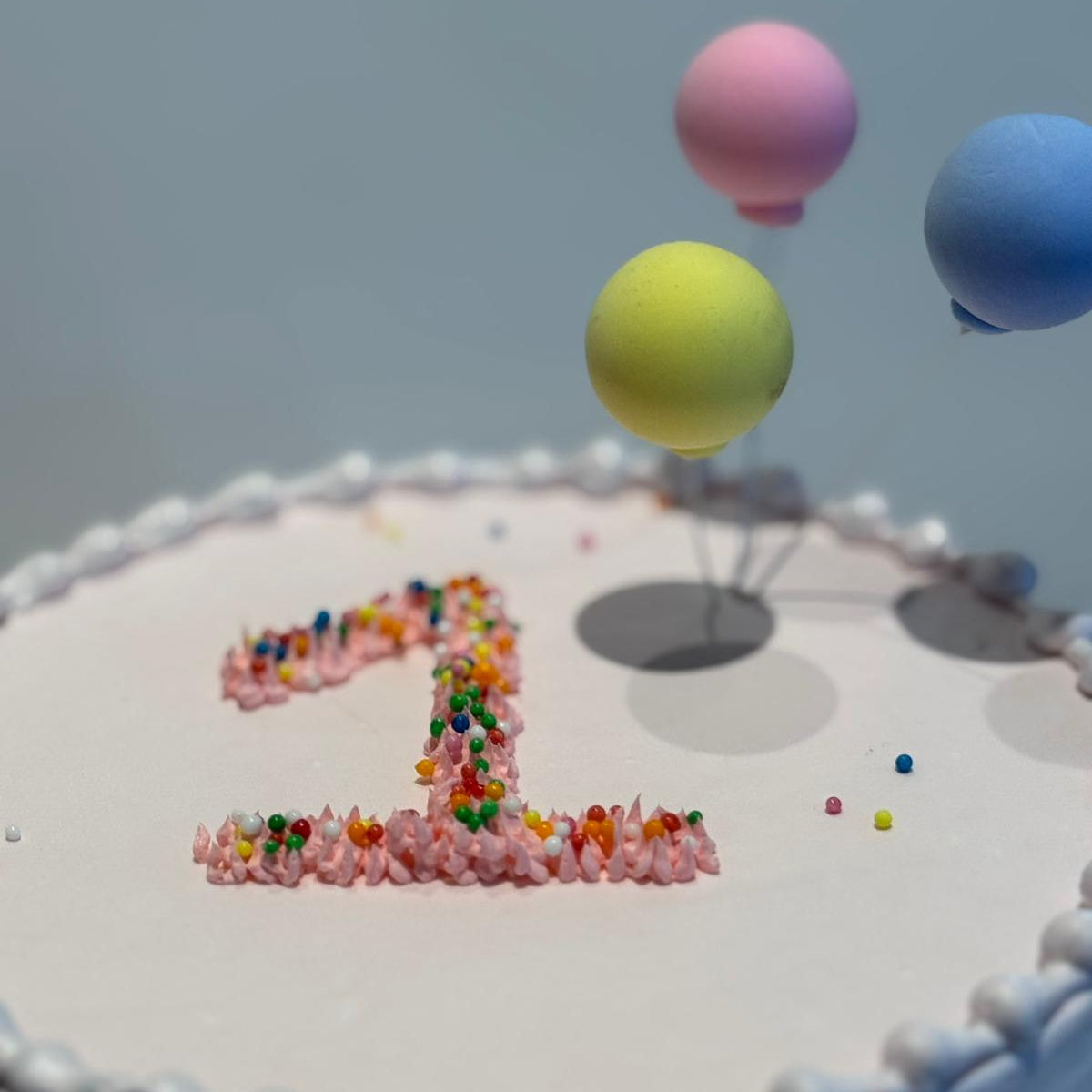 close up of a balloon-themed first birthday cake made with Ben & Jerry's ice cream in Adelaide, showcasing its playful celebration design.