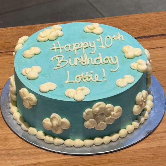 Full view of a fluffy clouds birthday ice cream cake featuring a dreamy cloud-inspired design for whimsical birthday celebrations.