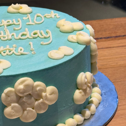 Side view of a handcrafted fluffy clouds ice cream cake highlighting its cloud-inspired decorative details and dreamy design.