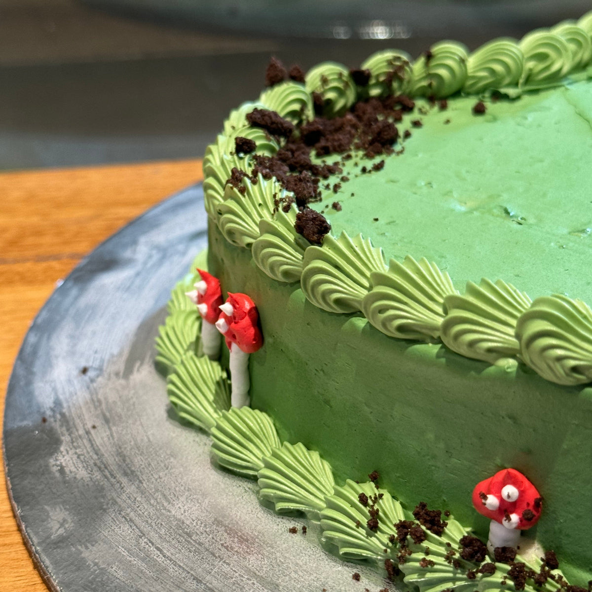 close up of a heart-shaped mushroom cake made with Ben & Jerry's ice cream in Adelaide, showcasing its playful forest and Oreo-inspired details.