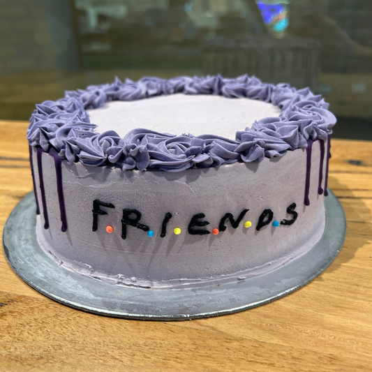 Full view of a Friends TV show birthday cake handcrafted in Adelaide using Ben & Jerry's ice cream, featuring nostalgic sitcom-inspired decorations.
