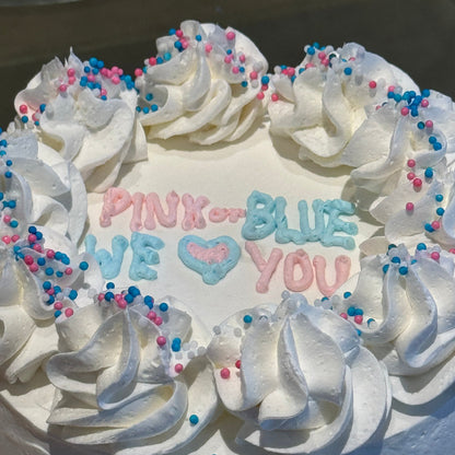 Close-up of the gender reveal-themed decorations on a celebration cake handcrafted in Adelaide using Ben & Jerry's ice cream.