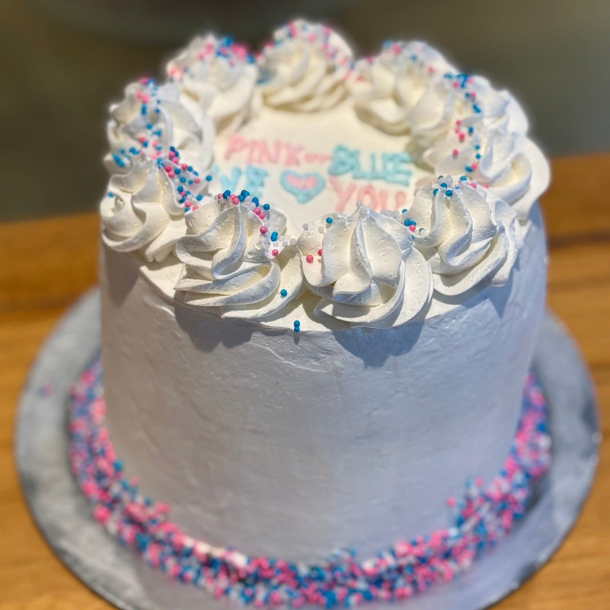 Front view of a gender reveal celebration cake made with Ben & Jerry's ice cream in Adelaide, showcasing its baby reveal-themed presentation.