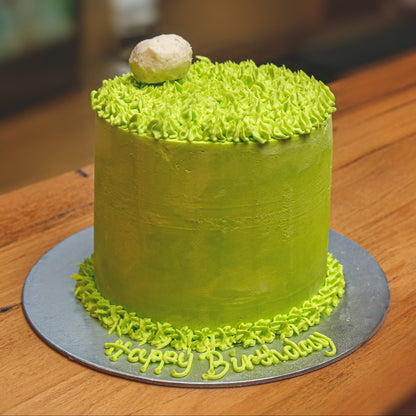 Front view of a handcrafted golf ice cream cake showcasing its tall shape and golf-inspired birthday decorations.