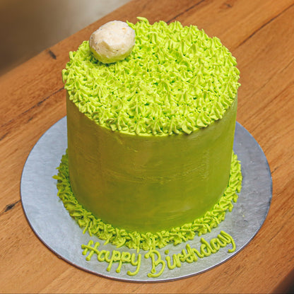 Full view of a tall golf birthday ice cream cake featuring golf-themed decorations and a distinctive upright design for a golfer's celebration.