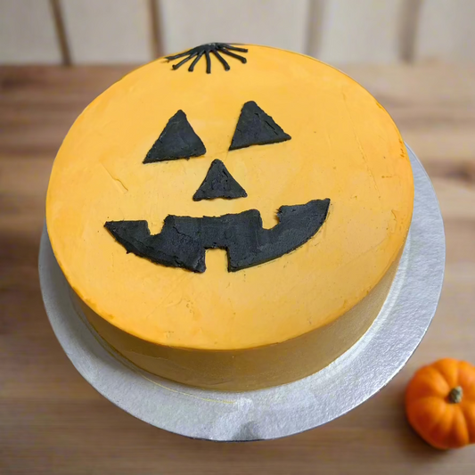 top  view of a scary pumpkin Halloween cake handcrafted in Adelaide using Ben & Jerry's ice cream, featuring a spooky jack-o'-lantern-inspired face.