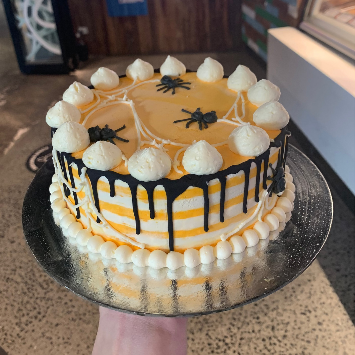 Full view of a Halloween spider and cobweb cake handcrafted in Adelaide using Ben & Jerry's ice cream, featuring spooky spider web-inspired decorations.