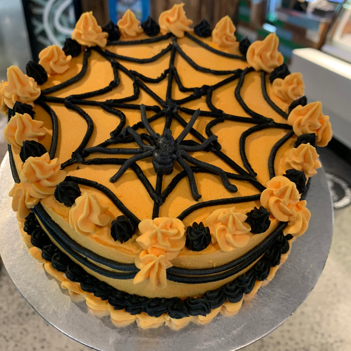 top view of a Halloween spider web birthday cake made with Ben & Jerry's ice cream in Adelaide, showcasing its creepy spider and cobweb styling.