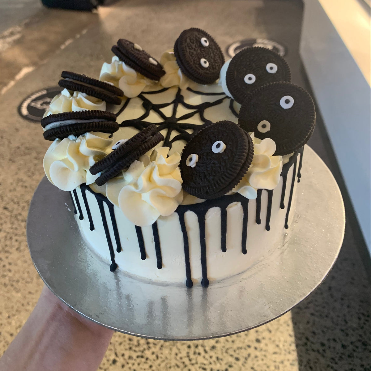 top view of a handcrafted Halloween ice cream cake made using Ben & Jerry's ice cream in Adelaide, highlighting its spooky spider-themed presentation.