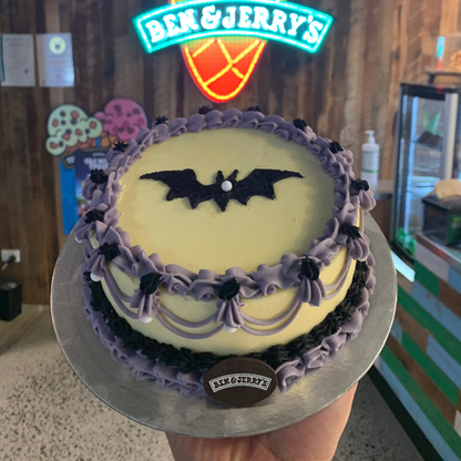 top view of a purple and black vintage Halloween cake handcrafted in Adelaide using Ben & Jerry's ice cream, featuring spooky bat-inspired decorations.
