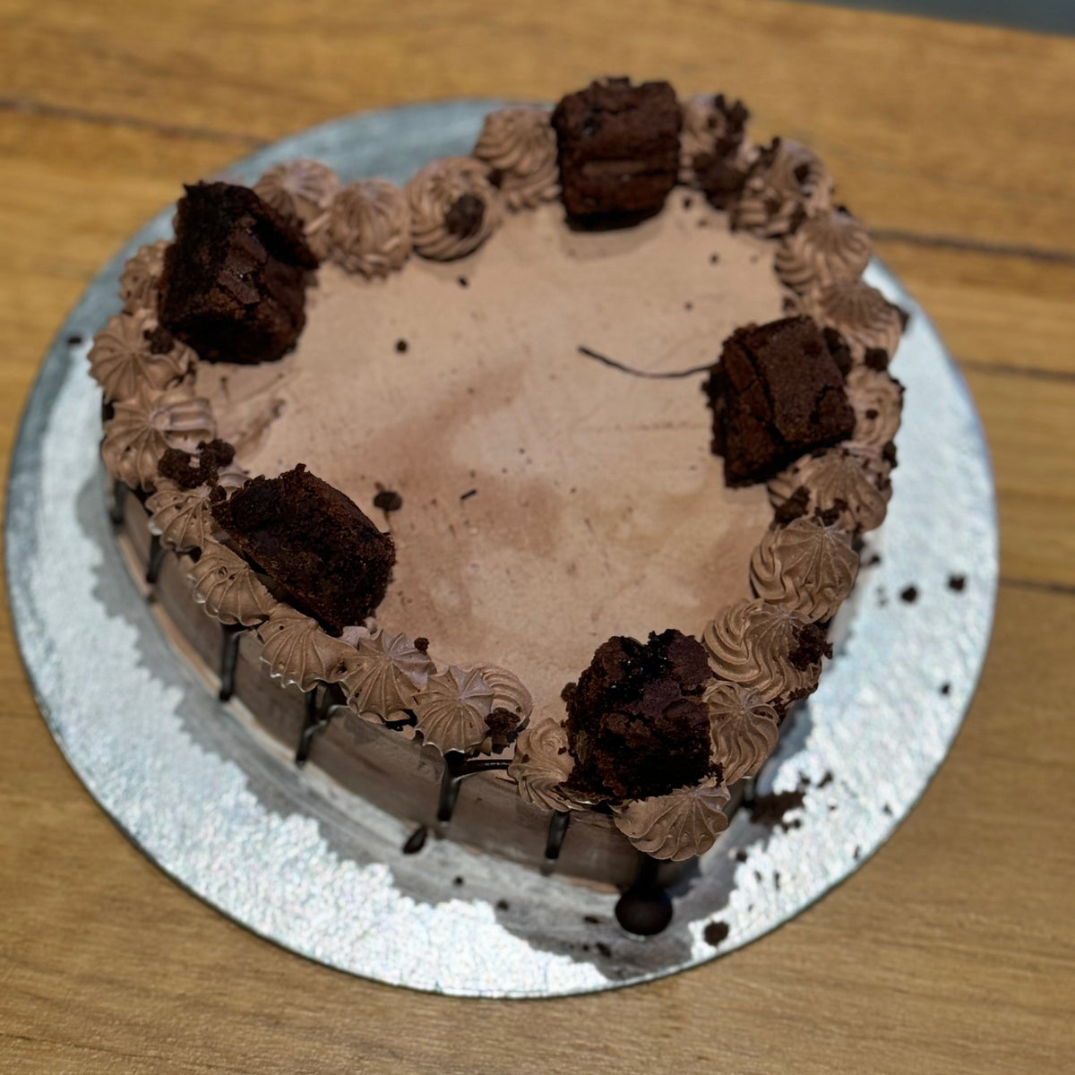 top view of a handcrafted chocolate fudge brownie heart ice cream cake in Adelaide made using Ben & Jerry's ice cream, highlighting its chocolate-themed finish.