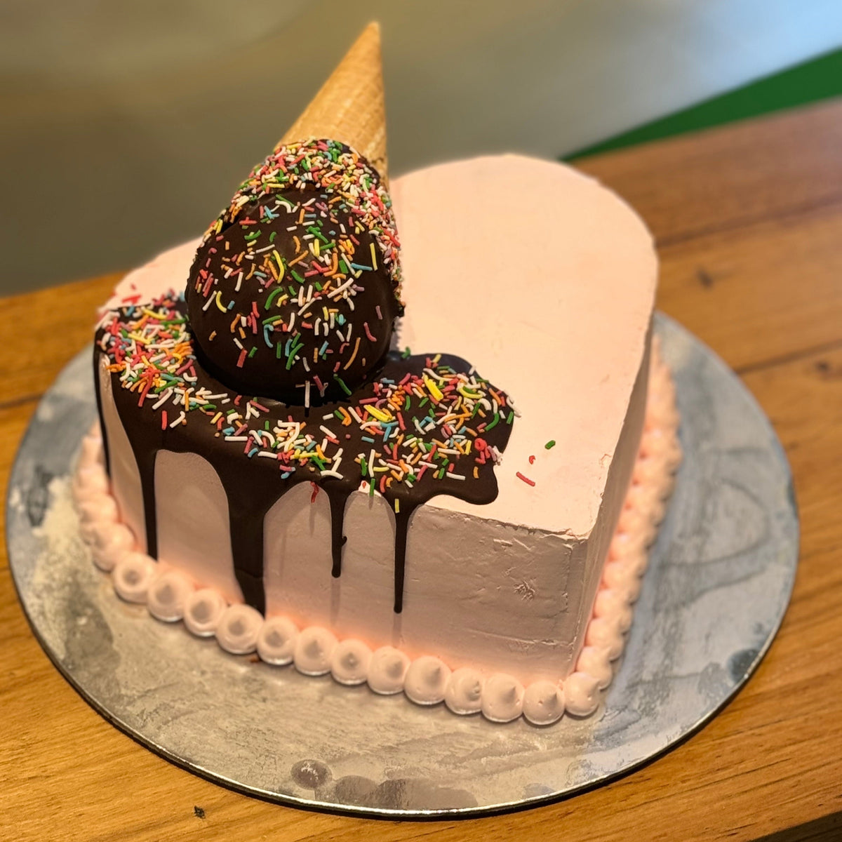 Full view of a heart-shaped melting cone birthday cake handcrafted in Adelaide using Ben & Jerry's ice cream, featuring a playful ice cream-inspired design.