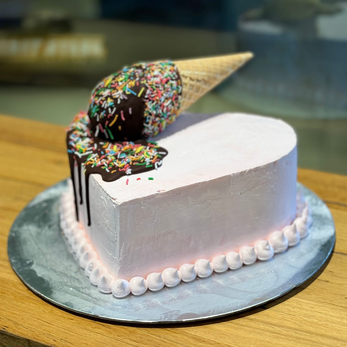 Side view of a handcrafted heart-shaped melting cone cake made using Ben & Jerry's ice cream in Adelaide, highlighting its romantic shape and whimsical styling.