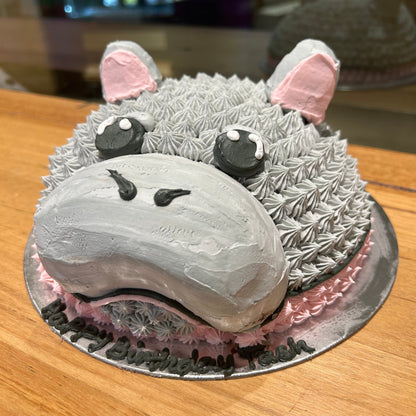 side view of a cute dome-shaped hippo birthday cake handcrafted in Adelaide using Ben & Jerry's ice cream, featuring an adorable animal design.