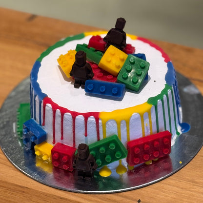 front of LEGO-inspired brick decorations on a children's birthday cake handcrafted in Adelaide using Ben & Jerry's ice cream.