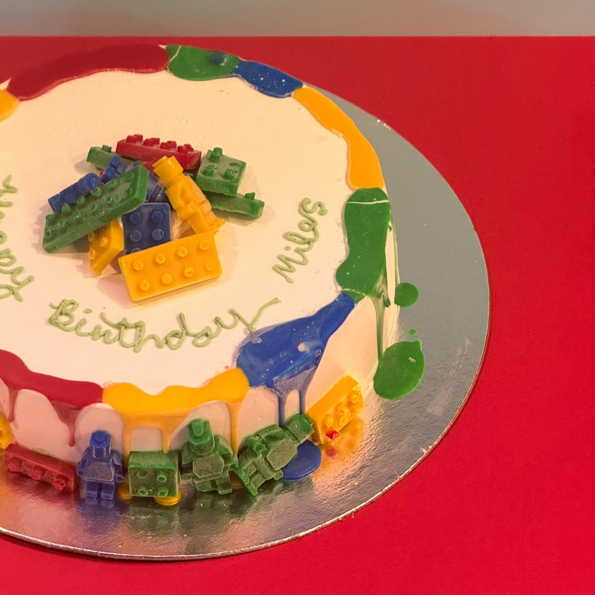 Side view of a handcrafted LEGO-themed ice cream cake in Adelaide made using Ben & Jerry's ice cream, highlighting its colourful building block design.