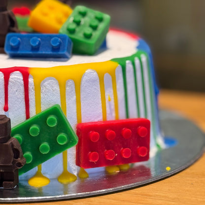 Close-up of LEGO-inspired brick decorations on a children's birthday cake handcrafted in Adelaide using Ben & Jerry's ice cream.