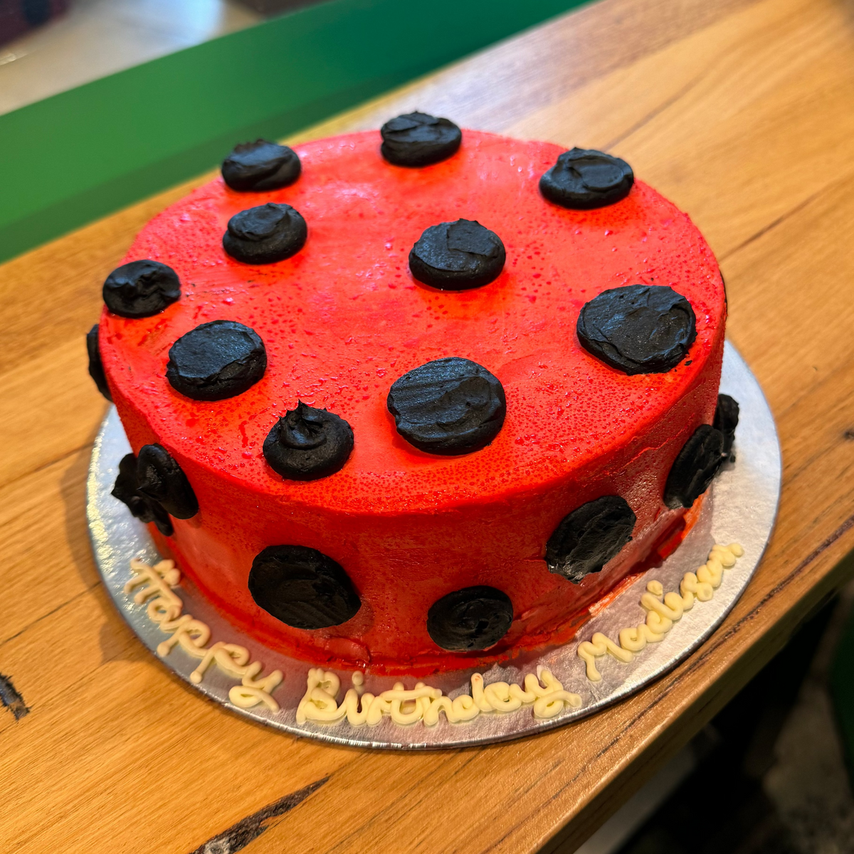 Full view of a ladybug-themed birthday cake handcrafted in Adelaide using Ben & Jerry's ice cream, featuring a cheerful garden insect-inspired design.