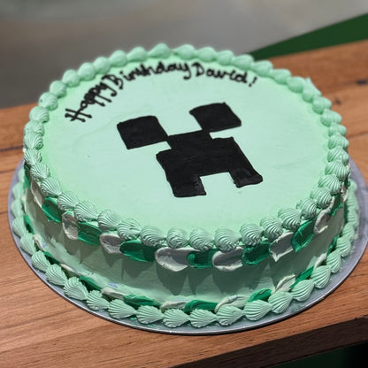 side view of a Minecraft Creeper ice cream cake showcasing the recognisable green Creeper face and block-inspired birthday design.