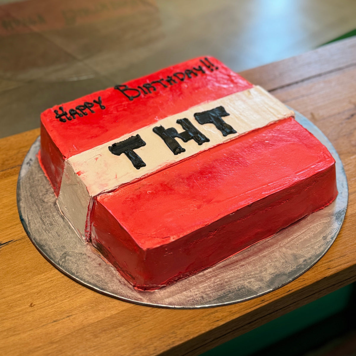 side view of a Minecraft TNT-themed birthday cake made with Ben & Jerry's ice cream in Adelaide, showcasing its recognisable pixel-inspired TNT block styling.
