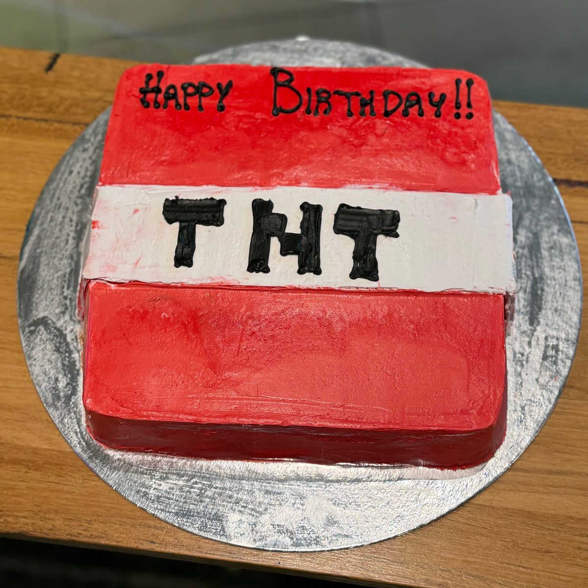 top view of a handcrafted square Minecraft TNT cake made using Ben & Jerry's ice cream in Adelaide, highlighting its block-shaped gaming design.
