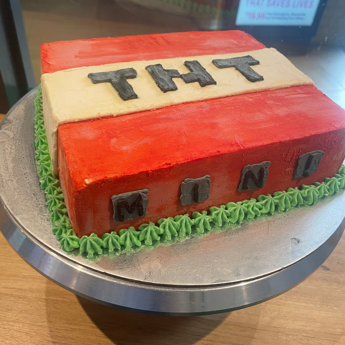 side view of the TNT-inspired decorations on a square Minecraft birthday cake handcrafted in Adelaide using Ben & Jerry's ice cream.