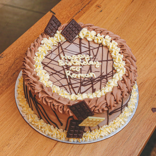 front view of Mini Chocolate Bars Loaded Ice Cream Cake stacked with assorted bite-size chocolates for birthday celebrations with Adelaide delivery
