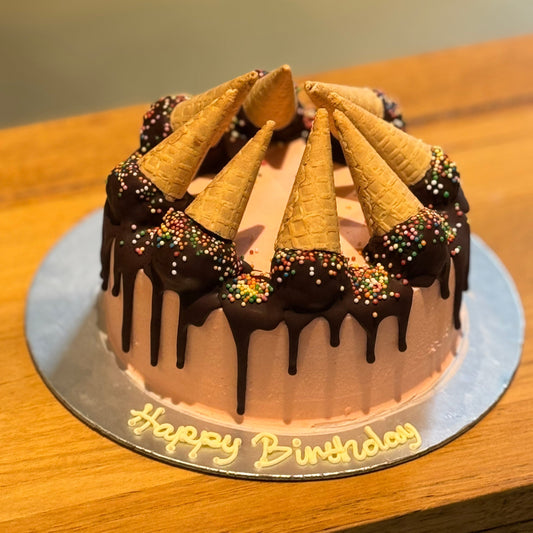 Full view of a Mini Melting Cones birthday cake handcrafted in Adelaide using Ben & Jerry's ice cream, featuring miniature cones and playful melting decorations.