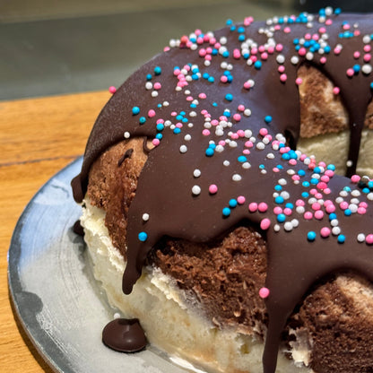 Close-up of playful donut decorations on a naked-style birthday cake handcrafted in Adelaide using Ben & Jerry's ice cream.