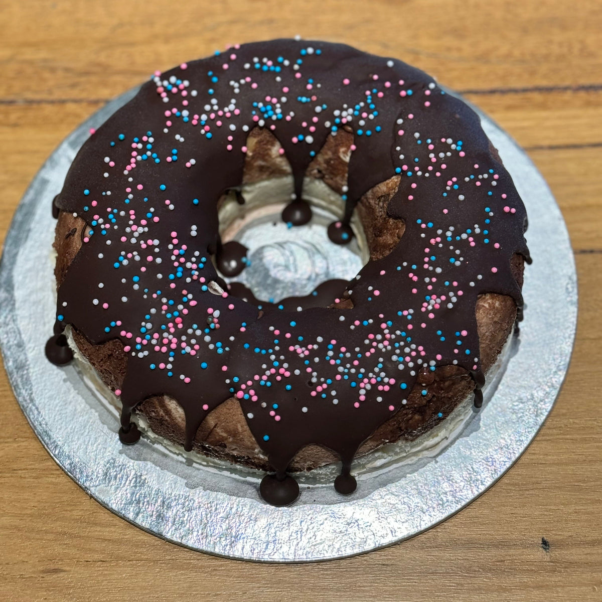 top view of a donut-themed birthday cake made with Ben & Jerry's ice cream in Adelaide, showcasing its minimalist naked-style finish.