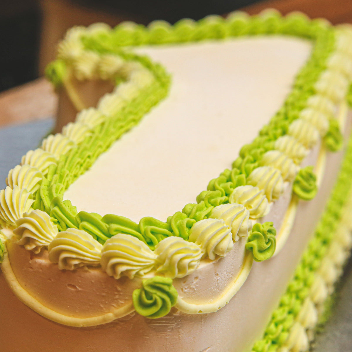 close up of a handcrafted number 1 birthday ice cream cake highlighting its shaped structure and decorative finish.