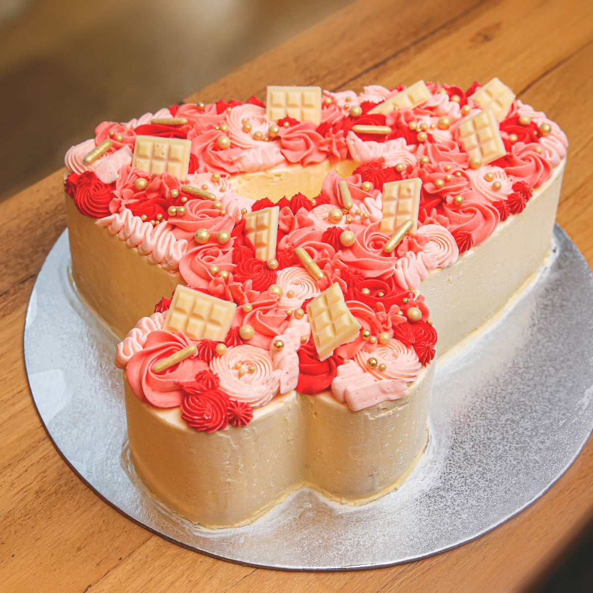 side view of a number four birthday cake showcasing its distinctive numeral-shaped design for a fourth birthday party.