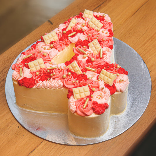 Full view of a handcrafted number 4-shaped ice cream cake designed for a child's fourth birthday celebration.