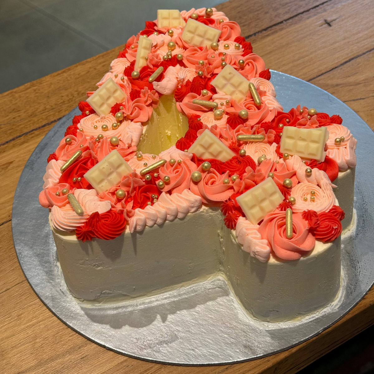 top view of a handcrafted number 4 birthday ice cream cake highlighting its shaped structure and decorative finish.