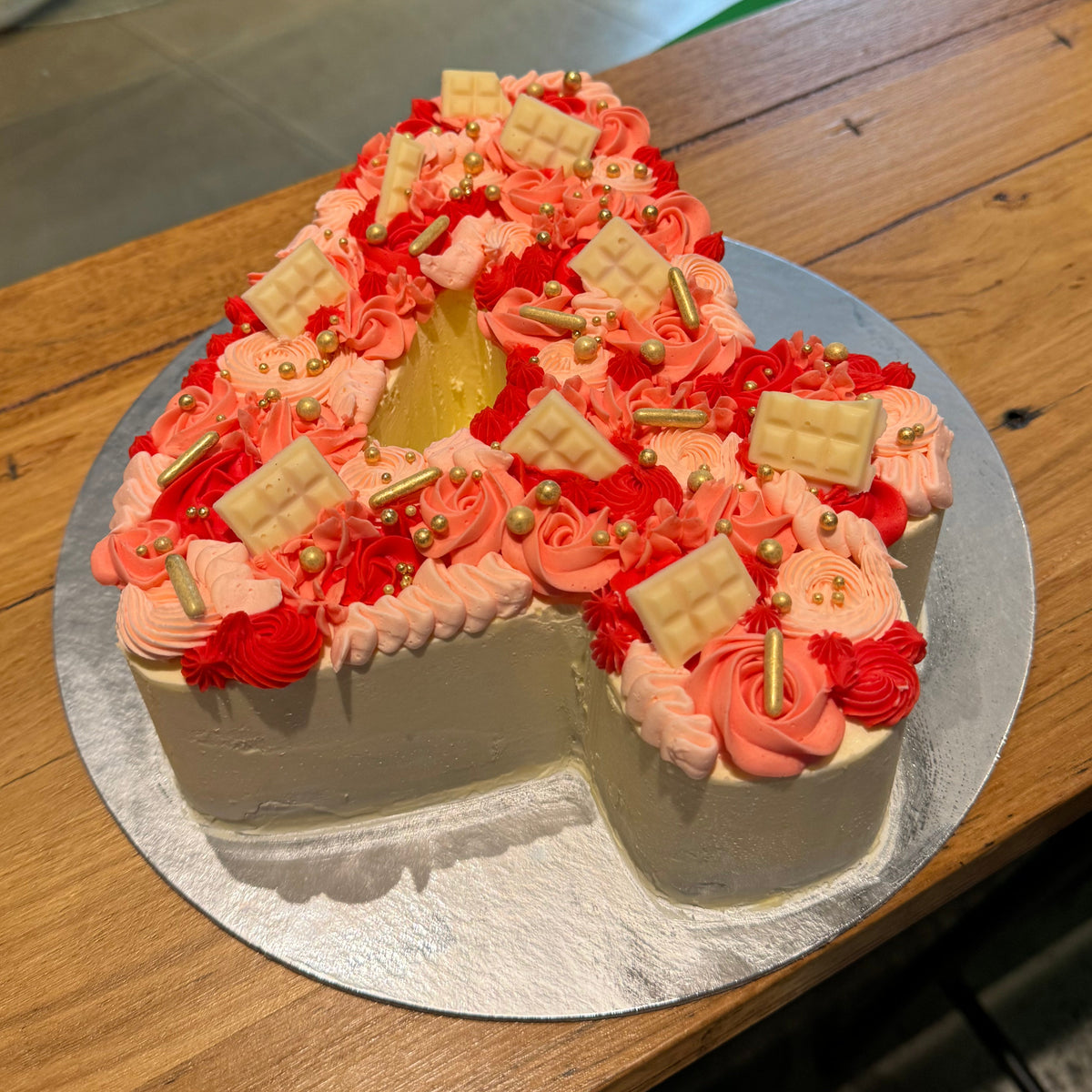 top view of the decorative details on a number 4-shaped birthday ice cream cake for a fourth birthday celebration.