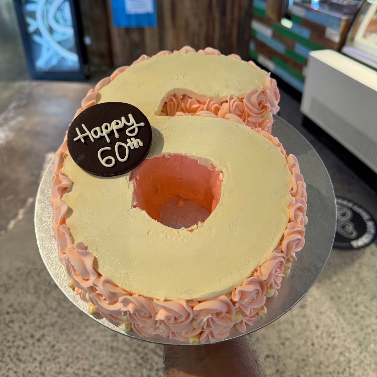 Full view of a number six birthday cake handcrafted in Adelaide using Ben & Jerry's ice cream, featuring a distinctive numeral-shaped design.