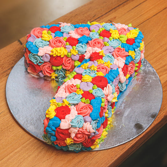Full view of a handcrafted number 7-shaped birthday ice cream cake designed for a child's seventh birthday celebration.