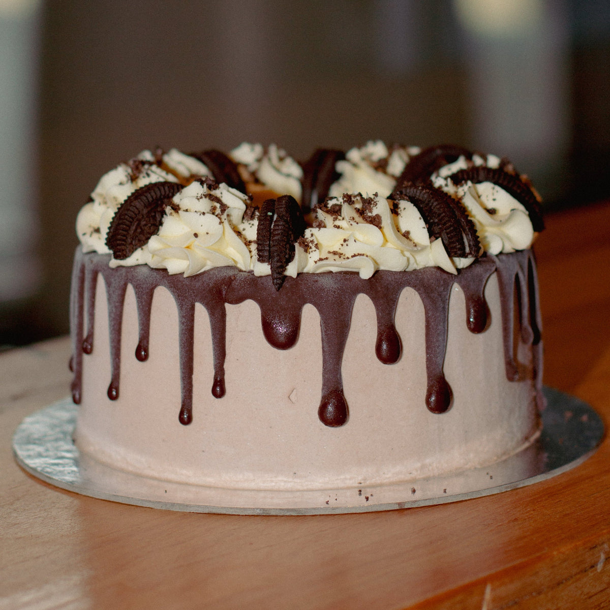 Full view of a chocolate Oreo drip ice cream cake featuring rich chocolate drips and Oreo cookie decorations for birthday celebrations.