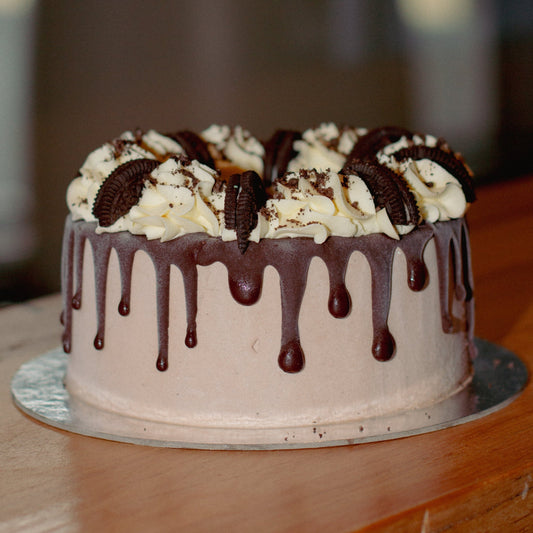 Full view of a chocolate Oreo drip ice cream cake featuring rich chocolate drips and Oreo cookie decorations for birthday celebrations.