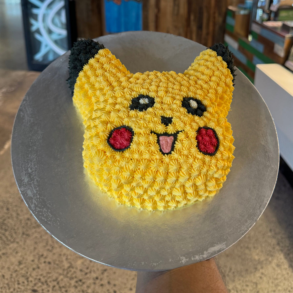 top view of a Pikachu-shaped cake made with Ben & Jerry's ice cream in Adelaide, showcasing its cheerful face and recognisable character details.