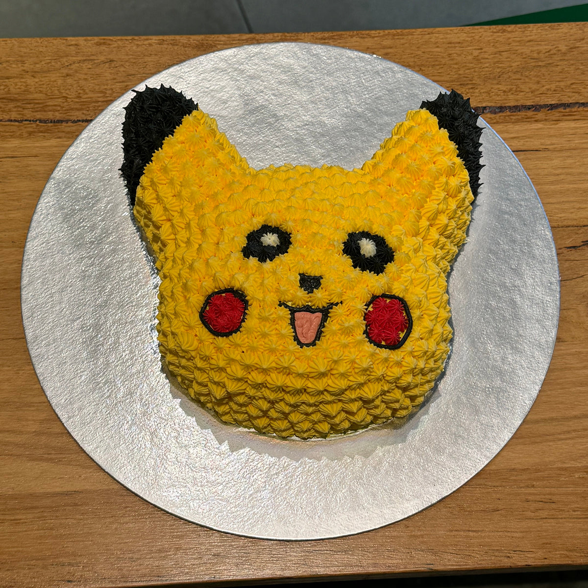 top view of a handcrafted Pikachu ice cream cake in Adelaide made using Ben & Jerry's ice cream, highlighting its distinctive character-inspired shape.