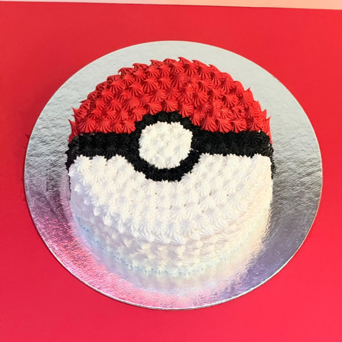 Top view of the Pokeball Round Ice Cream Cake handcrafted in Adelaide with Ben & Jerry’s ice cream and classic Pokémon-inspired styling.