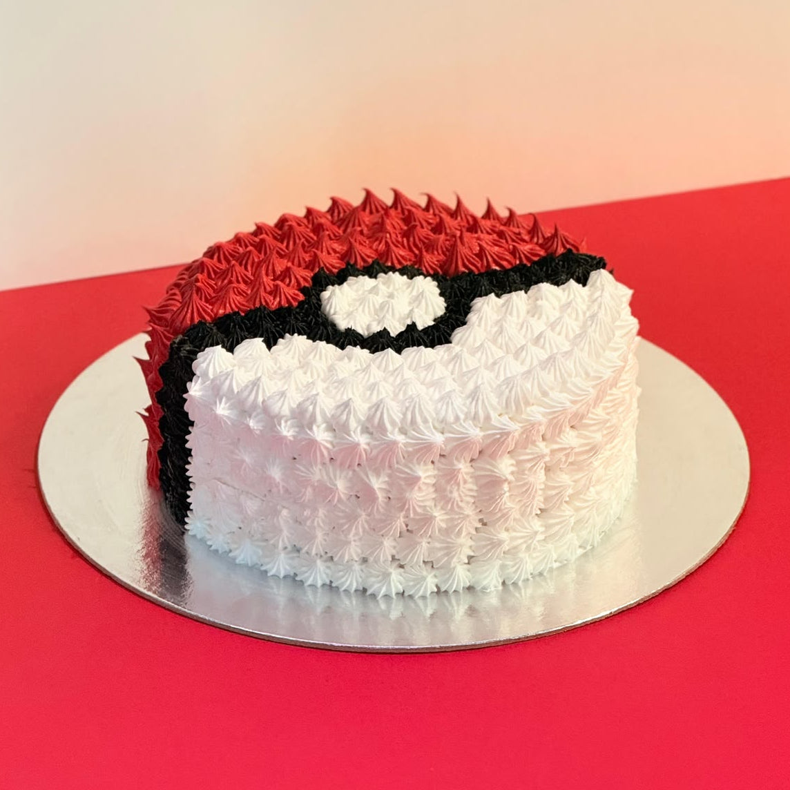 front view of the Pokeball Round Ice Cream Cake showcasing the handcrafted Poké Ball-inspired design for a Pokémon-themed birthday in Adelaide.