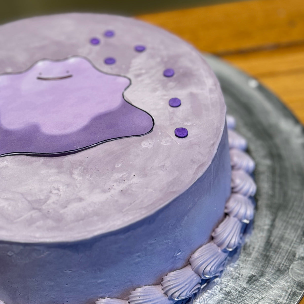 side view of a Ditto-themed cake made with Ben & Jerry's ice cream in Adelaide, showcasing the Pokémon's recognisable facial features.