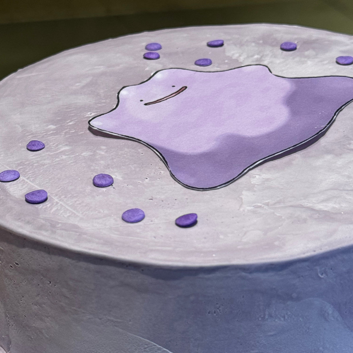 Close-up of the adorable Ditto-inspired facial details on a birthday cake made in Adelaide using Ben & Jerry's ice cream.