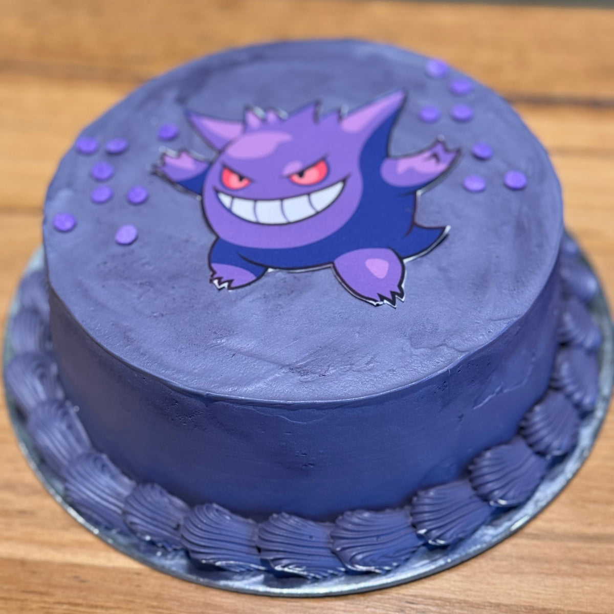 Full view of a Pokémon Gengar birthday cake handcrafted in Adelaide using Ben & Jerry's ice cream, featuring a playful purple Ghost-type theme.