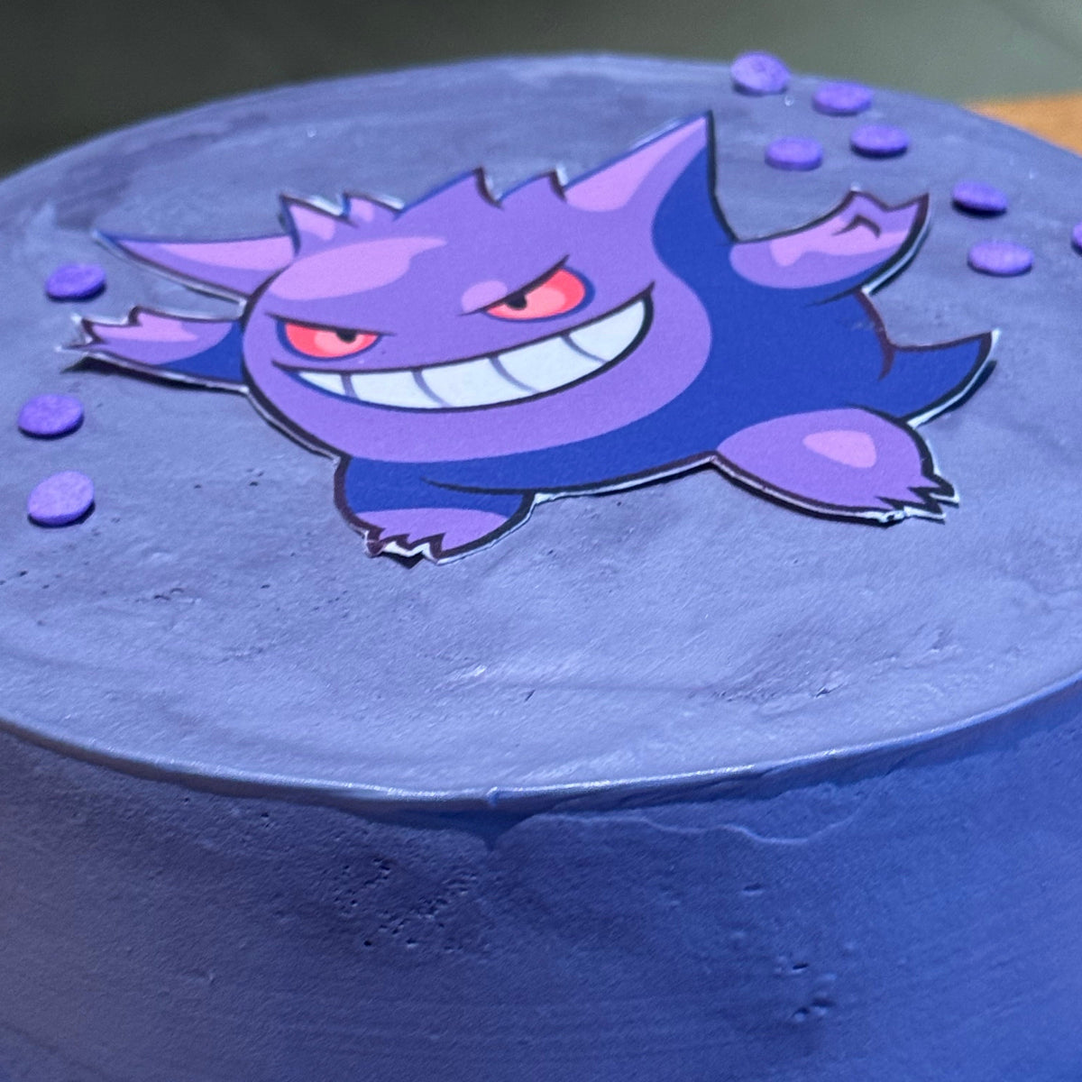 Close-up of Gengar-inspired decorative details on a Pokémon birthday cake made in Adelaide using Ben & Jerry's ice cream.