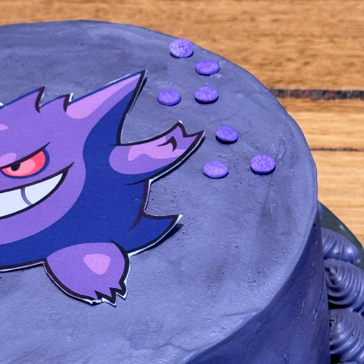close up of a purple Pokémon Gengar cake handcrafted in Adelaide using Ben & Jerry's ice cream, highlighting its themed decoration.
